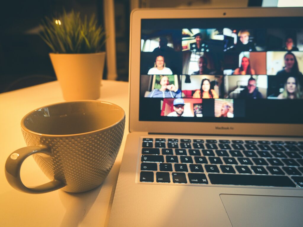 Laptop with a tea cup to showcase online conference call