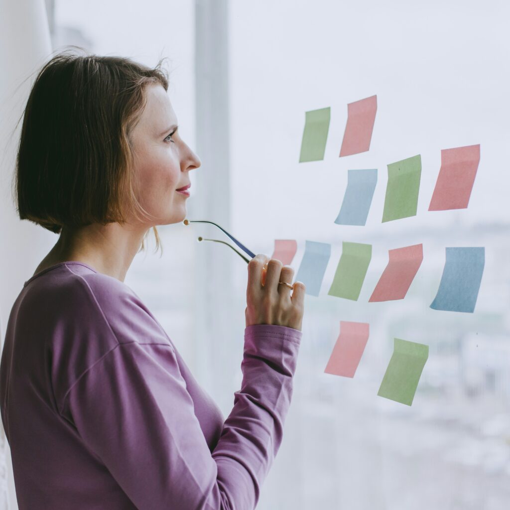 Woman looking at sticky notes