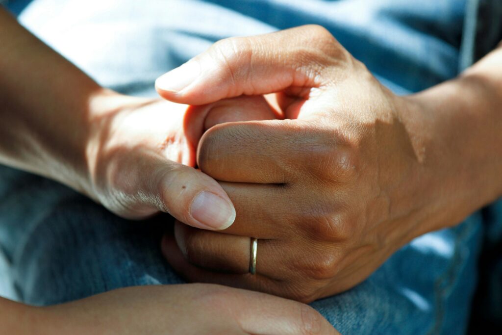 People holding hands in support.