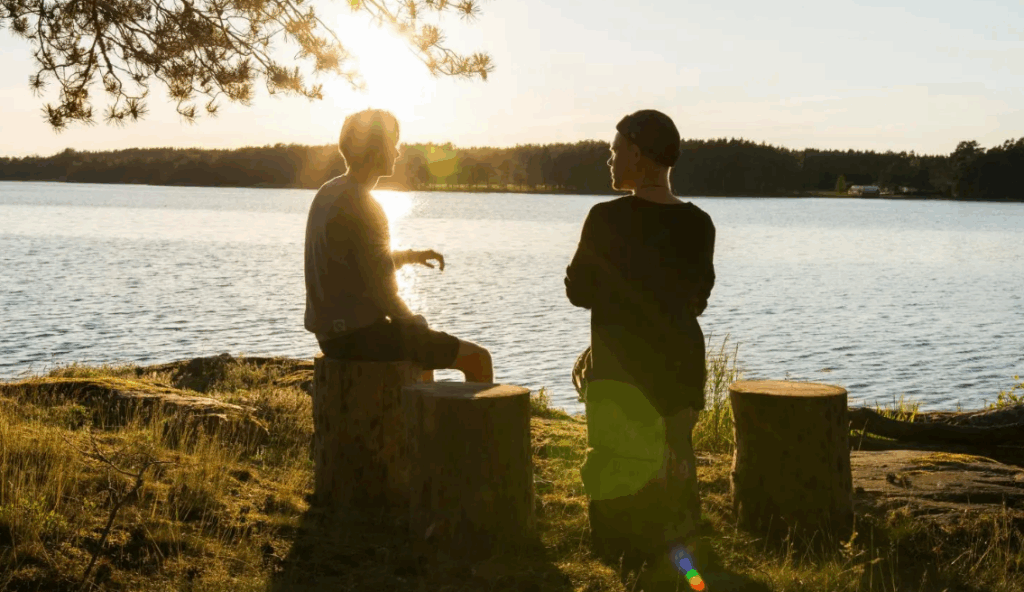 Two people sitting and talking outside